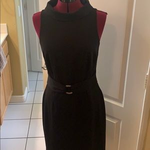 Expertly tailored black sheath.